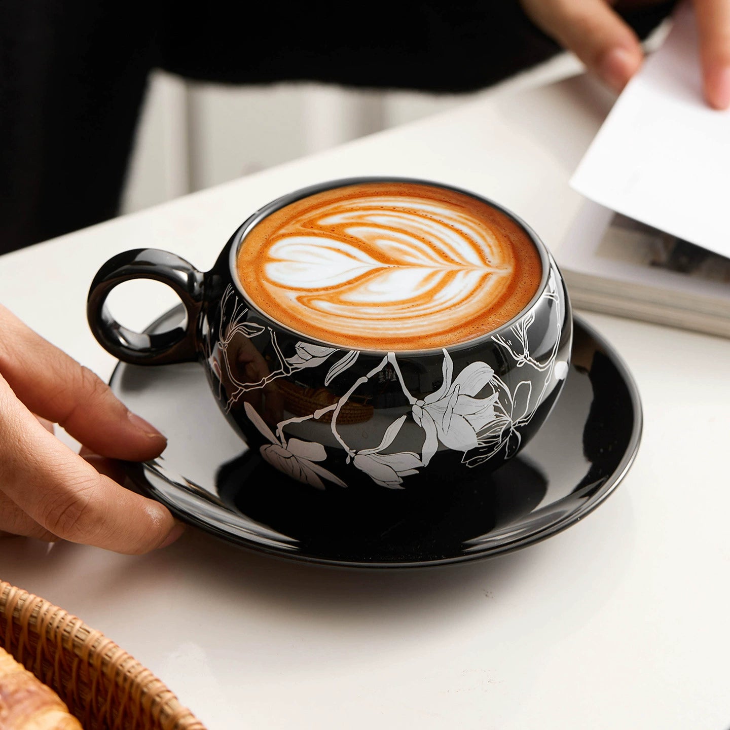 Black and white floral ceramic cup with matching plate