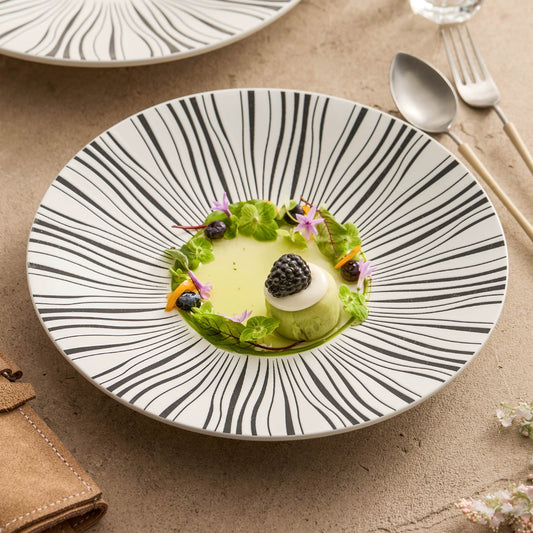 Black ceramic plate with radiant line pattern

