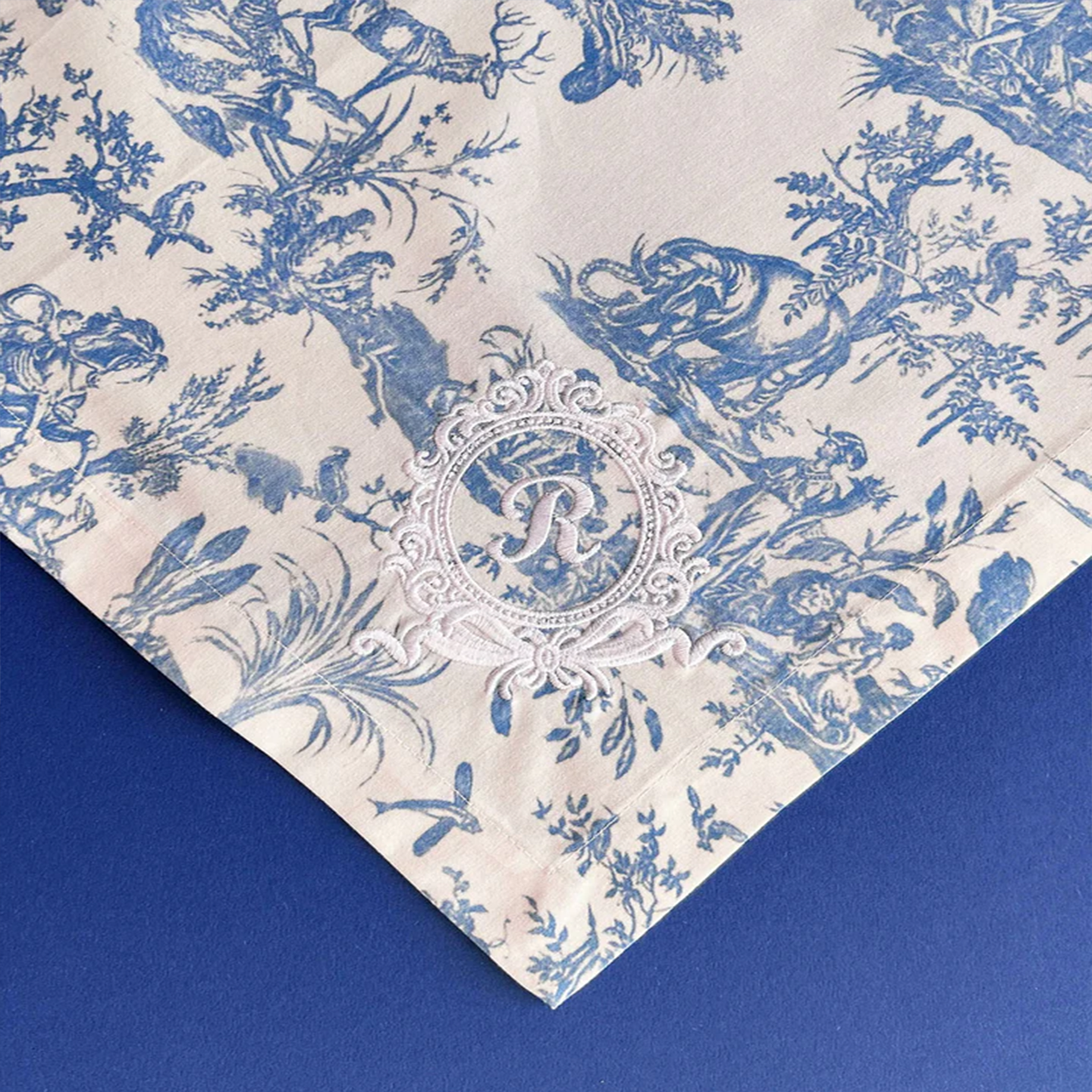 Blue Toile de Jouy textile shown as a functional yet decorative kitchen tea towel.
