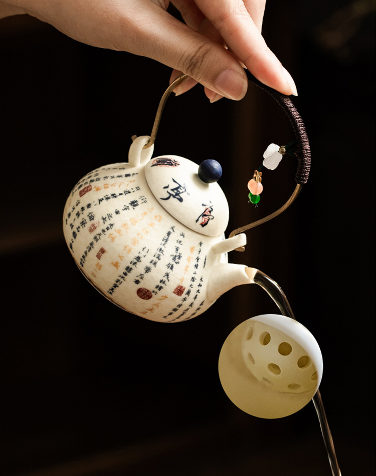 Brass handle teapot with woven rattan wrap