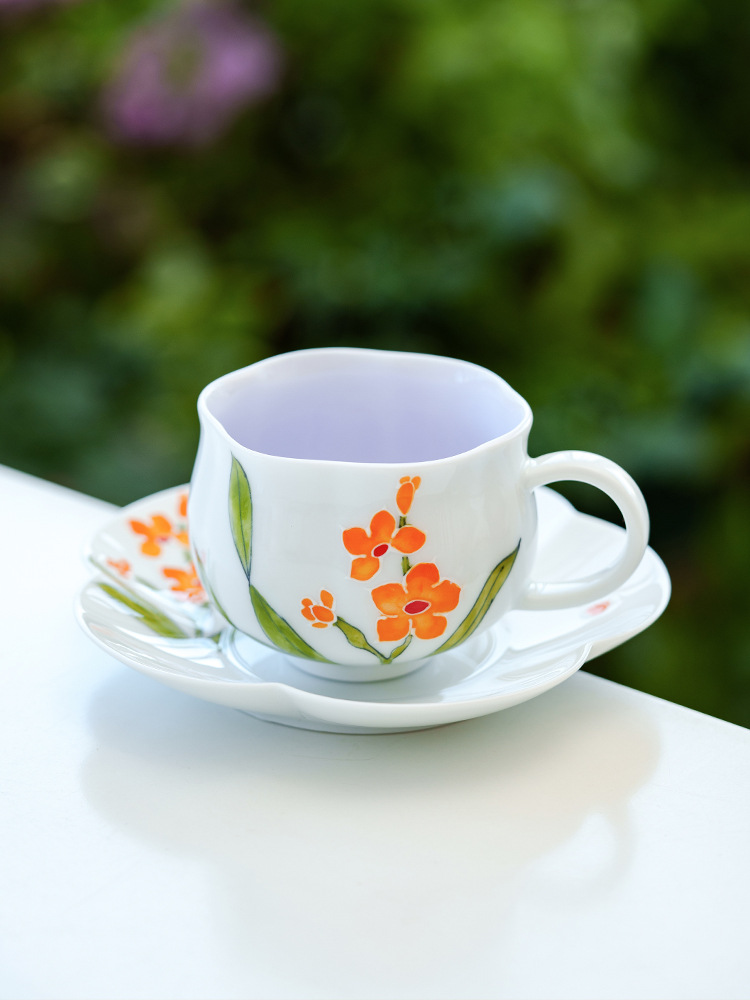 Bright orange blossom porcelain cup symbolizing vitality and warmth