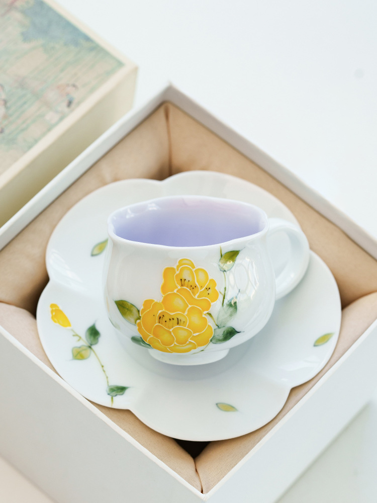 Bright yellow peony ceramic teacup symbolizing joy and elegance