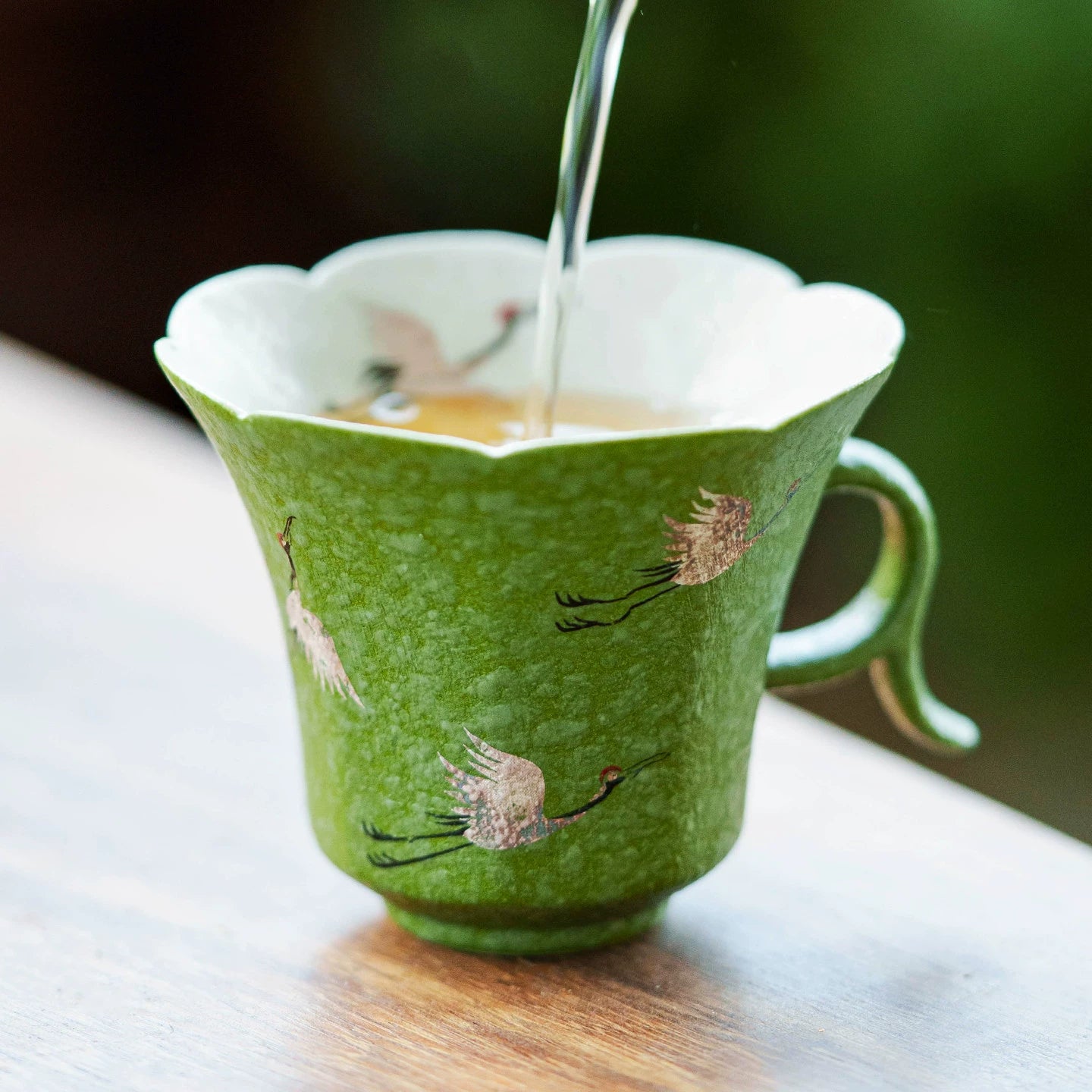 Celadon green tea cup with curved handle — handcrafted porcelain by GOSEUNG