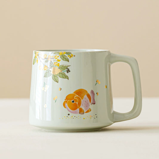 Celadon porcelain mug featuring golden koi and blossoms