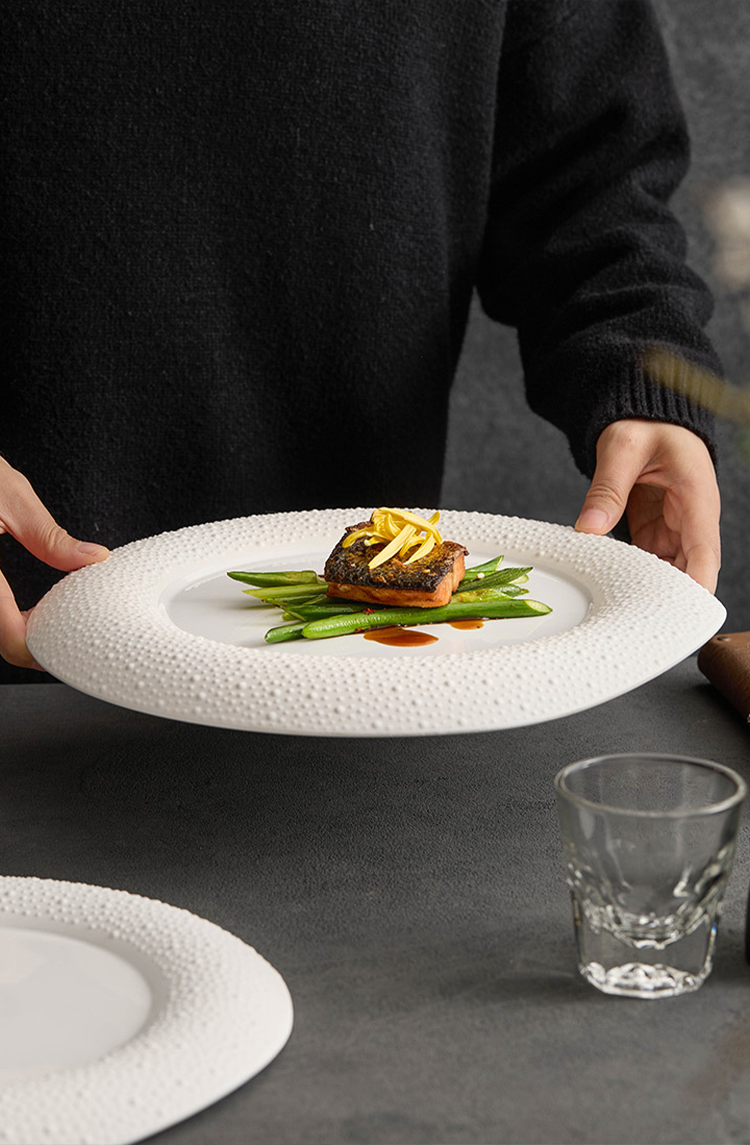 Ceramic dinner plate styled for fine dining presentation with artistic plating.