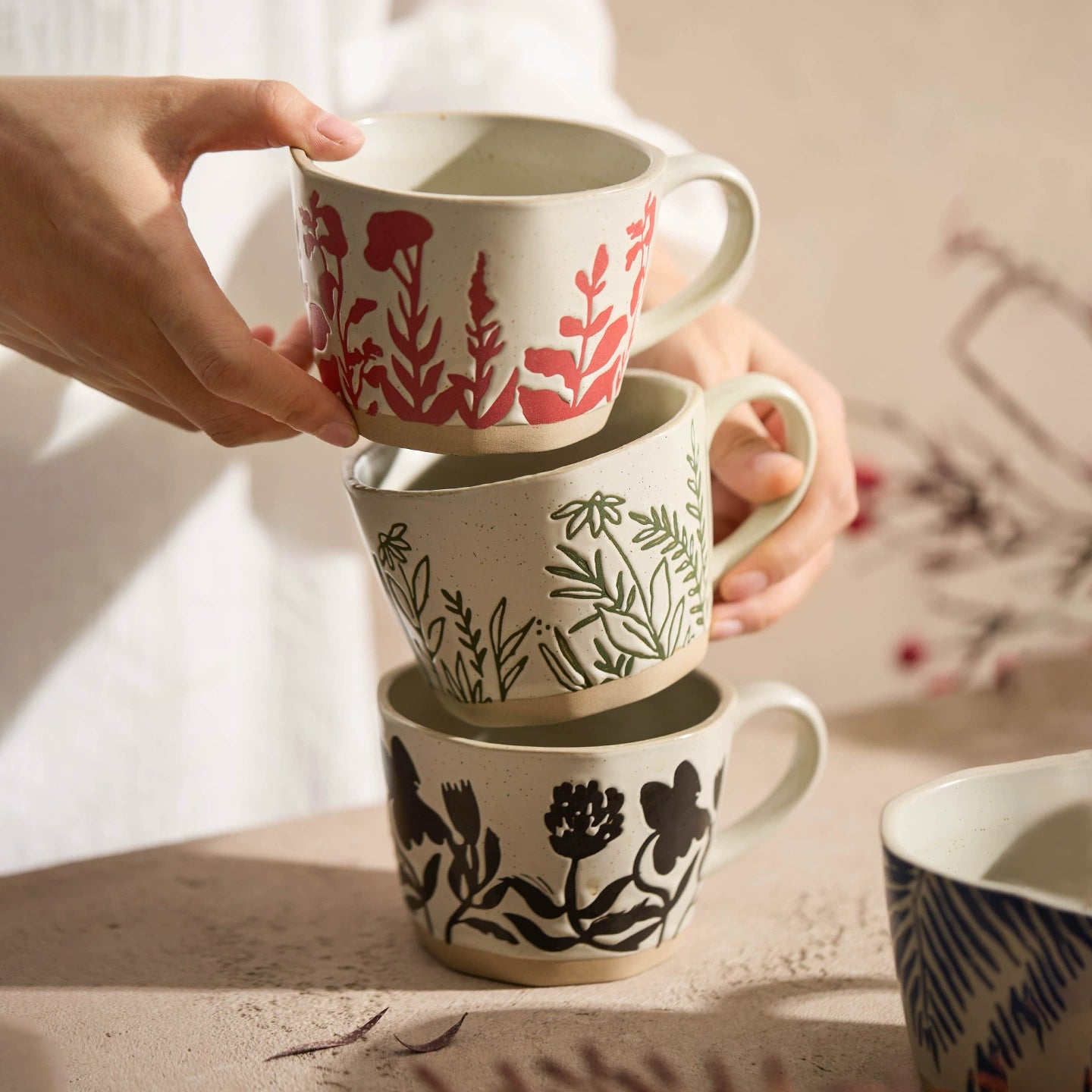 Ceramic mug featuring natural leaf and grass patterns