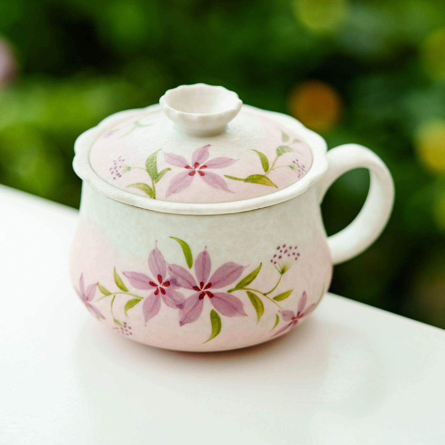 Ceramic tea cup featuring delicate hand-painted blossoms