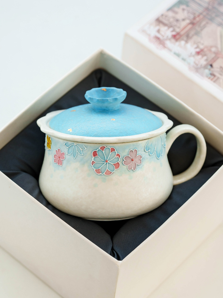 Ceramic tea cup set with floral detailing and lid