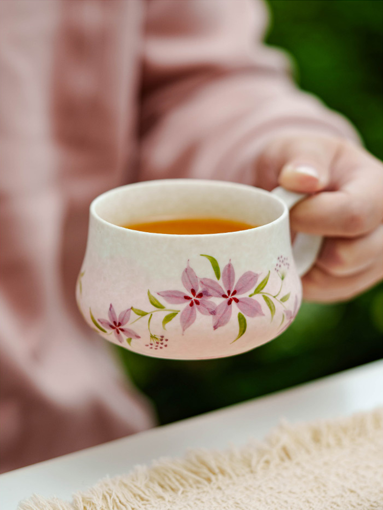 Ceramic tea cup with floral hand-painted details