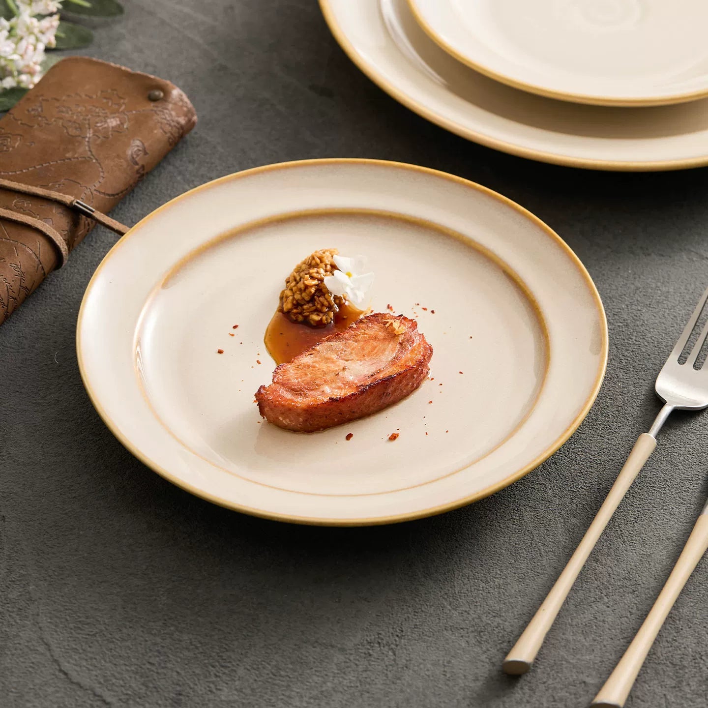 Circular kiln-glazed dinner plate with a central embossed cloud spiral motif.