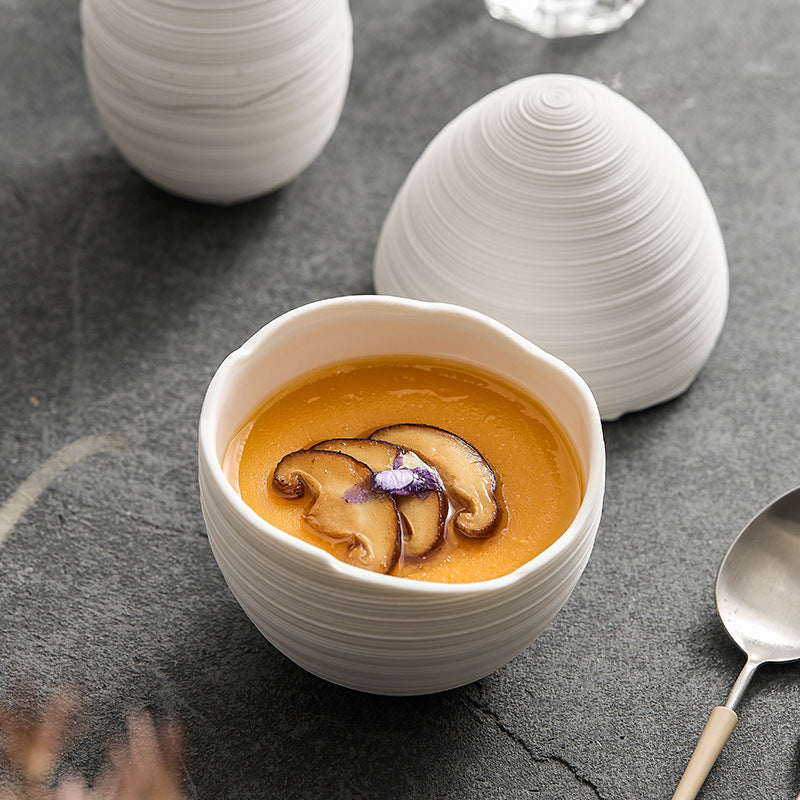 Close-up of ceramic bowl with embossed line texture

