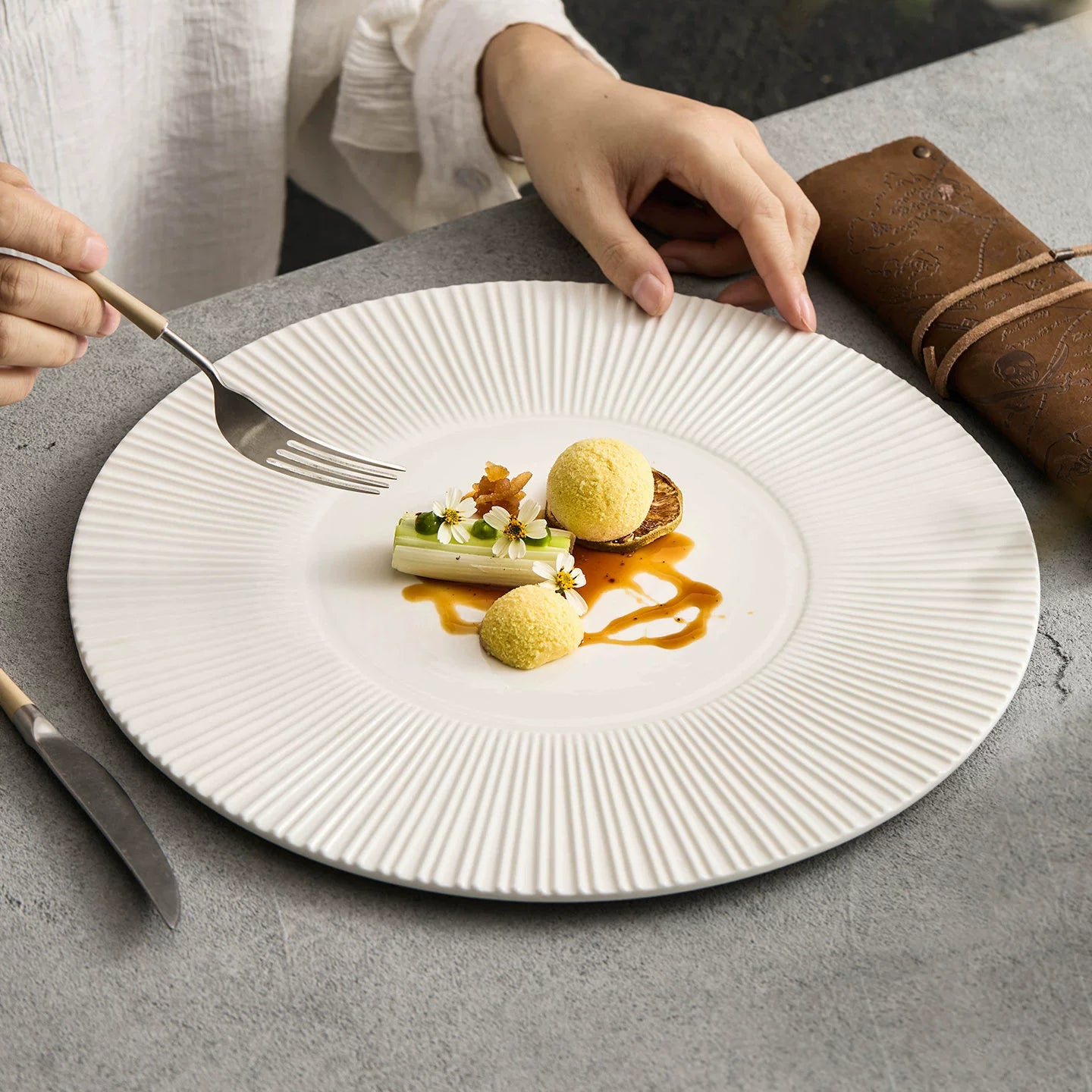Close-up of radial line texture on a high-fired white ceramic plate.