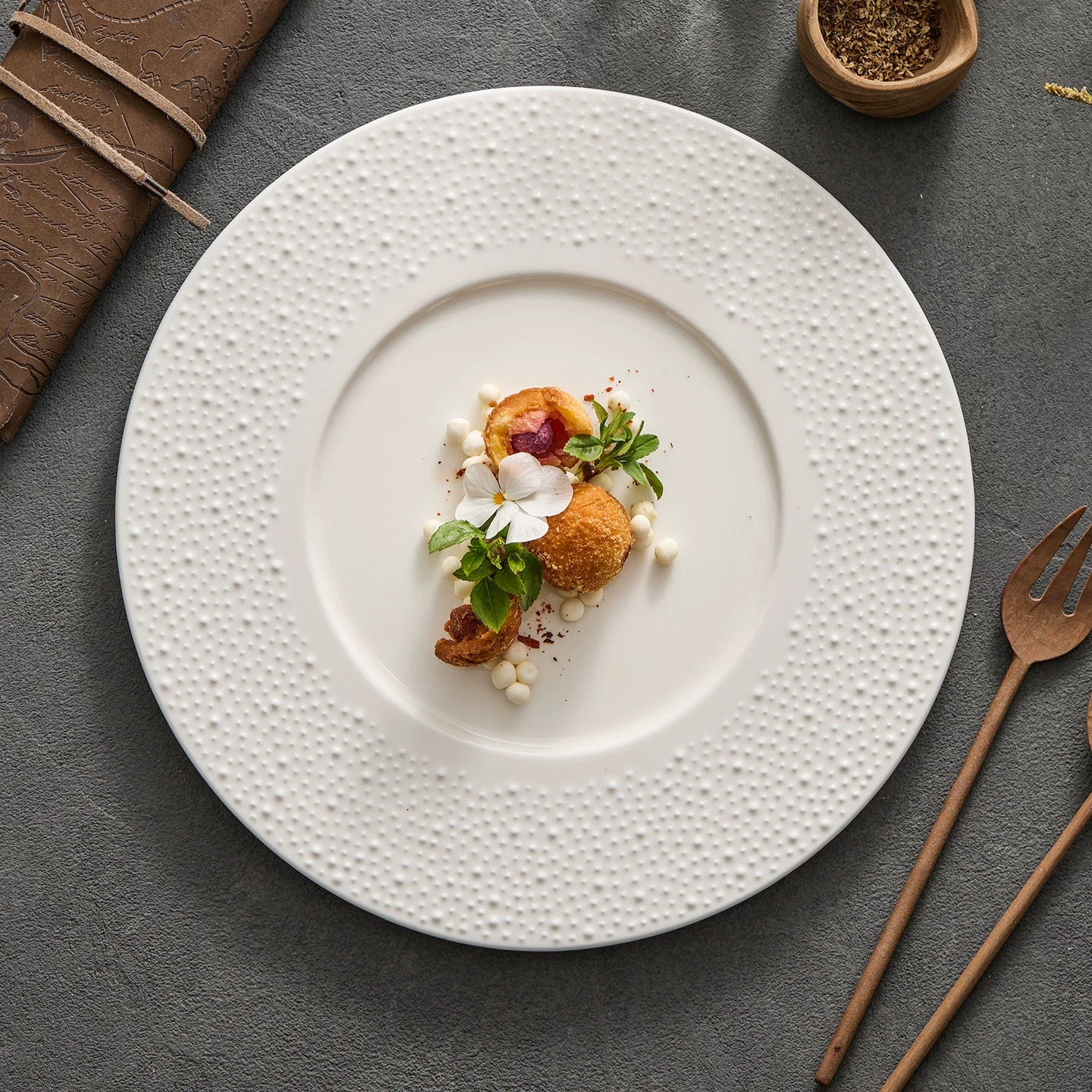 Close-up of the micro-textured ceramic surface on a GOSEUNG sesame point dinner plate.