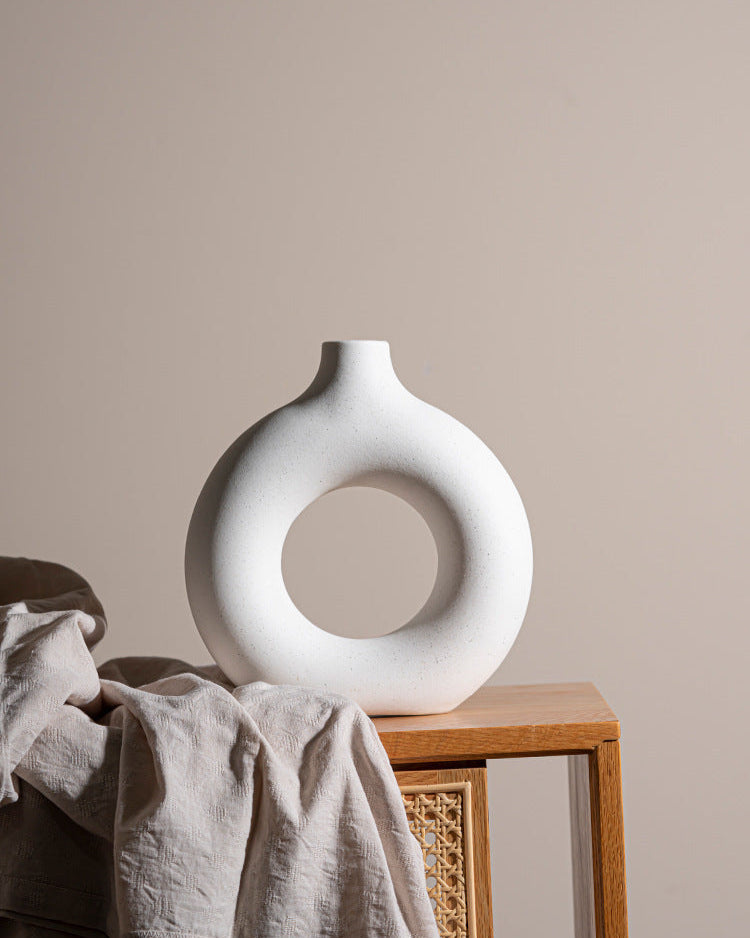 Art-inspired hollow vases in varying sizes on minimalist background

