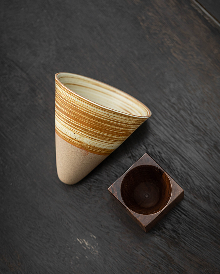 Cup and stand set on rustic table with natural light
