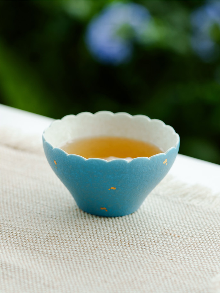 Decorative handmade tea cup with scalloped rim