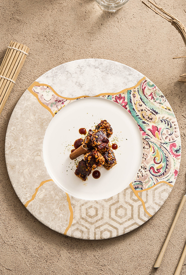 Decorative mosaic-style plate featuring gold accent lines and soft neutral tones