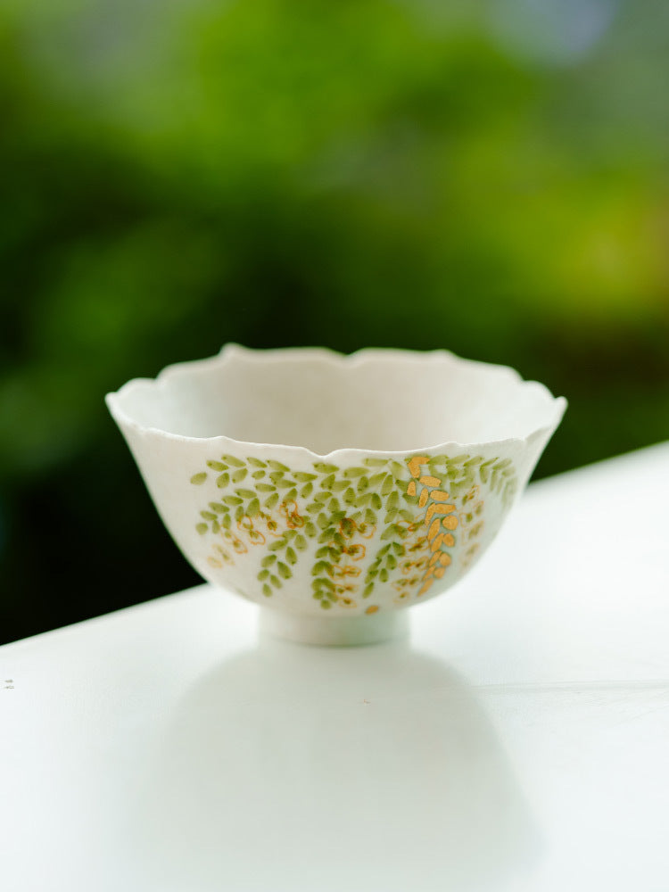 Decorative petite ceramic teacup with foliage artwork