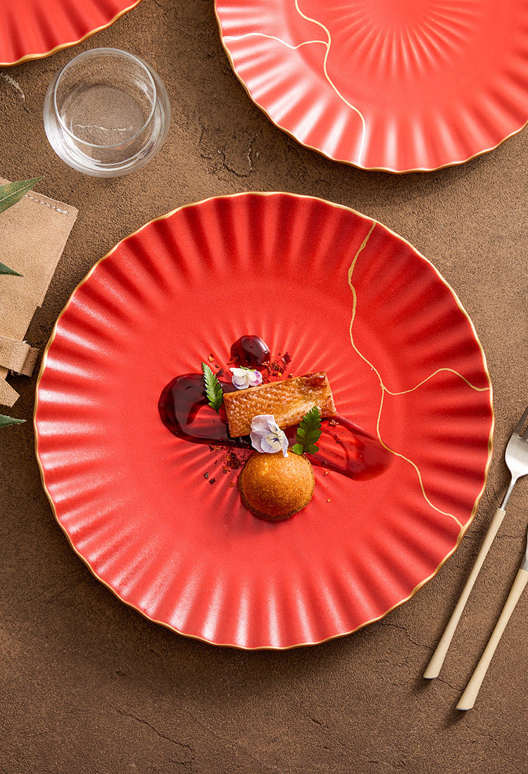 Decorative round red ceramic dish with gold edge