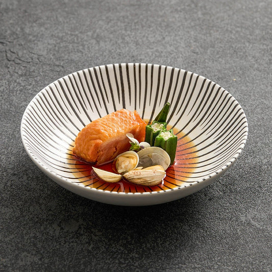 Deep ceramic plate with sunburst line pattern

