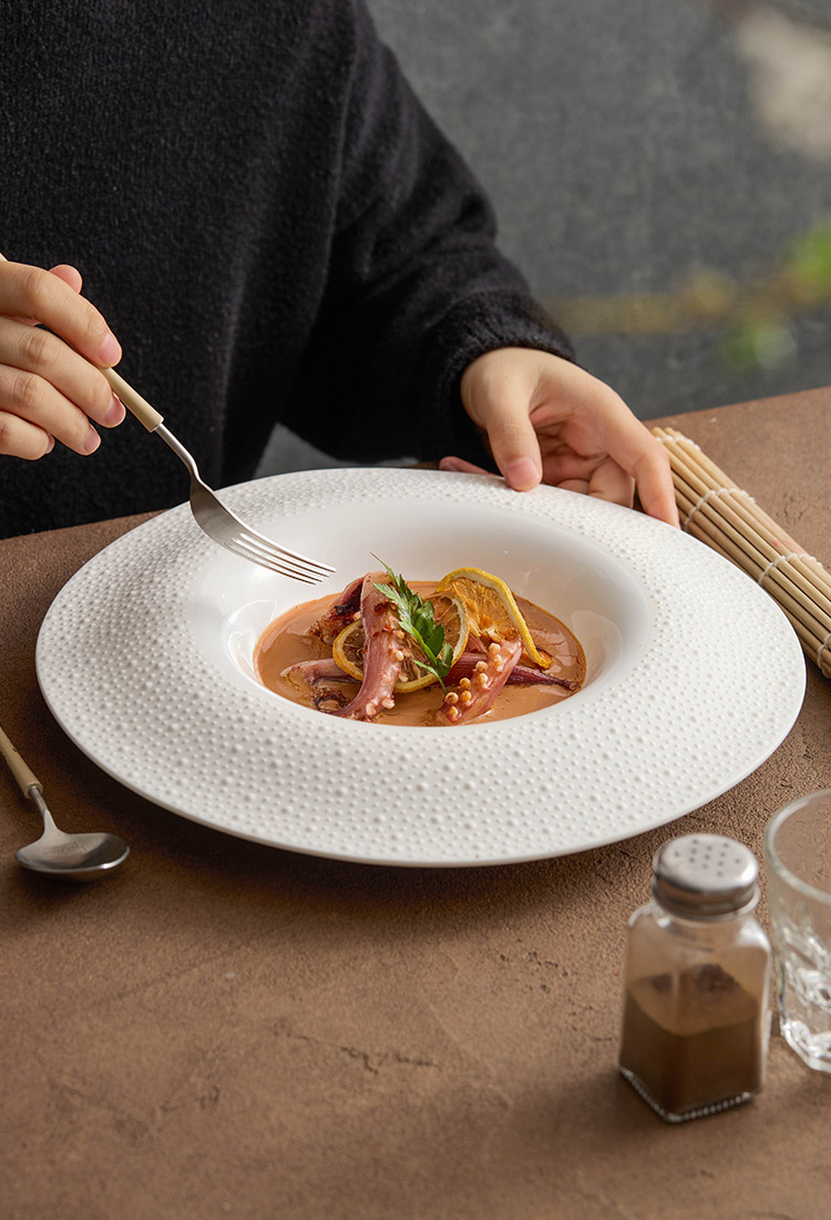 Deep rim bowl-shaped ceramic dinner plate