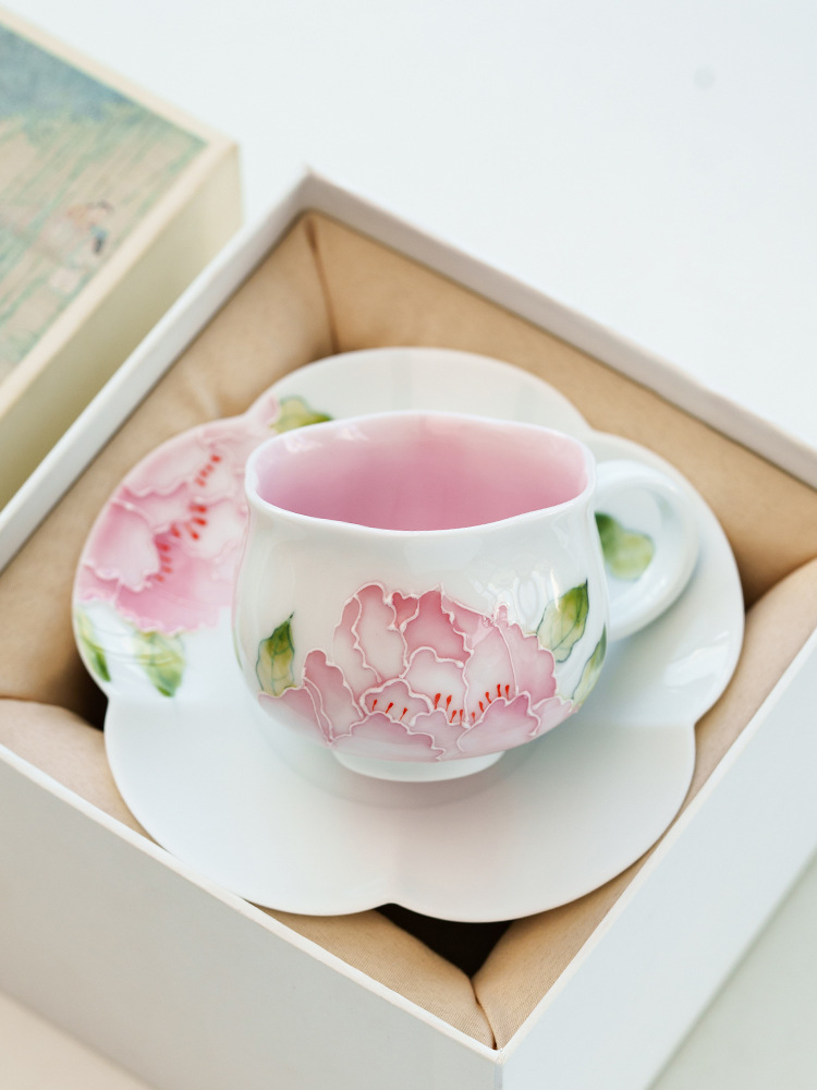 Delicate pink floral porcelain teacup with matching saucer for elegant tea time