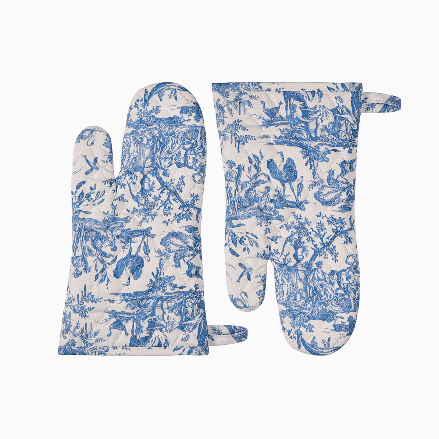 Detailed view of the blue Toile de Jouy oven mitt with pastoral motifs and a signature red logo tag.