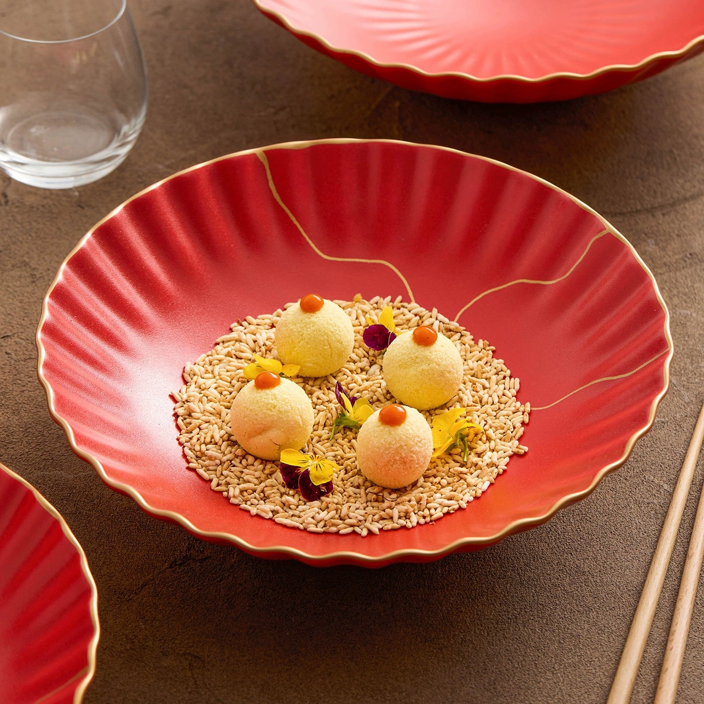 Red plate with dessert on a brown surface