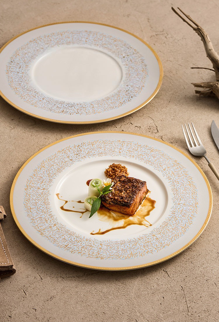 Elegant blue-rim plate with gold detailing on table