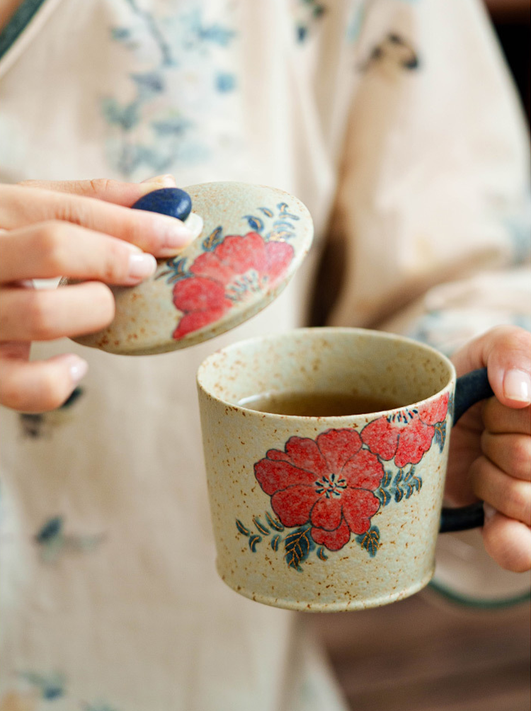 Elegant ceramic mug set with hand-painted red blossoms and wooden base