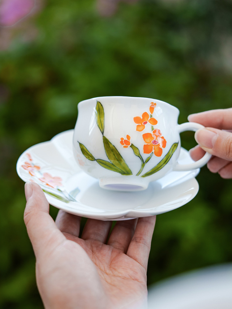 Elegant ceramic tea cup with petal-shaped saucer