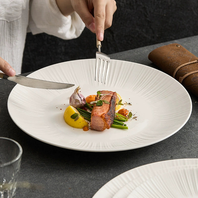 Elegant high-fired porcelain dinner plate with radial embossed lines.