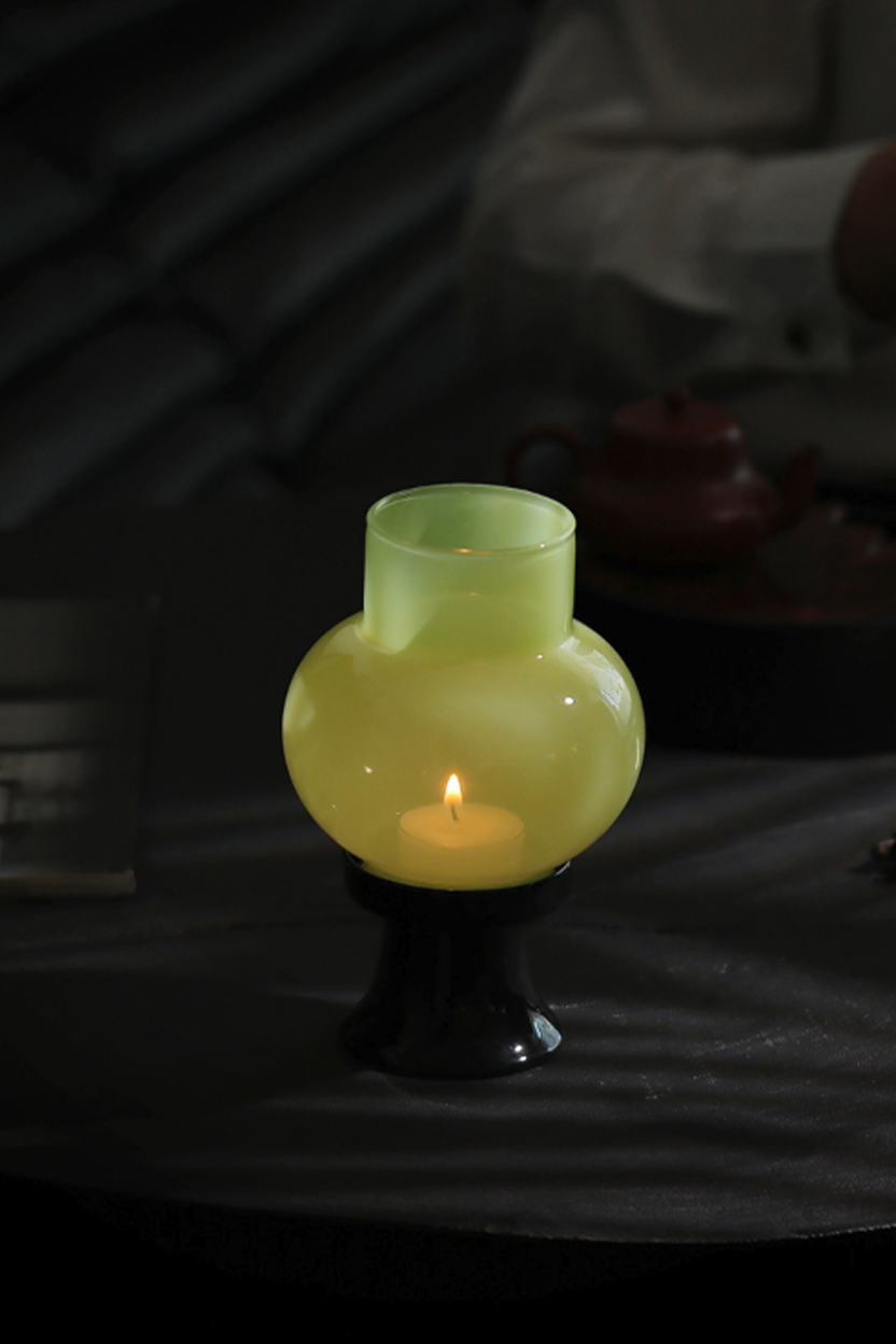 Elegant pink aroma candle holder for cozy bedroom or reading corner.