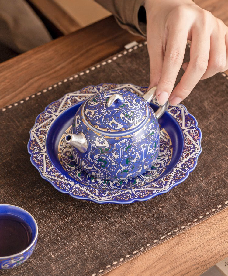 Elegant porcelain teapot with 999 silver decoration and dragon motif