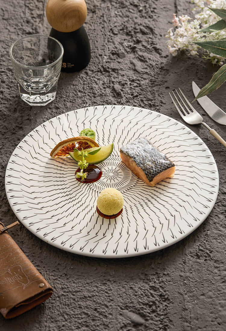 Dessert plate with gourmet food presentation on a textured surface