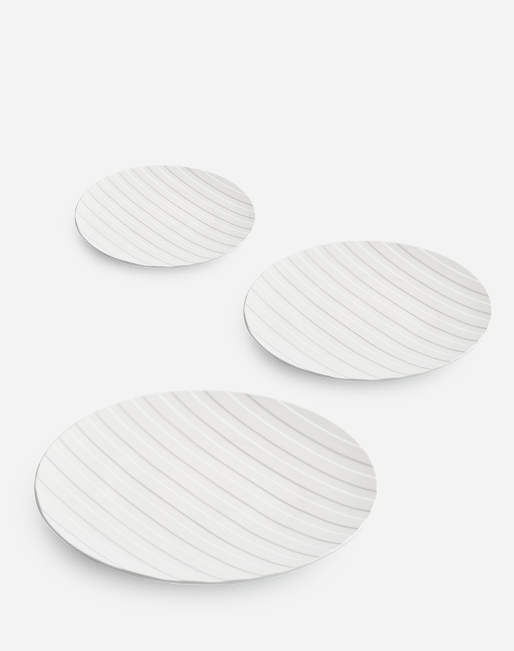 Elegant stripe relief porcelain dinner plate showcasing fine desserts and minimalist plating style