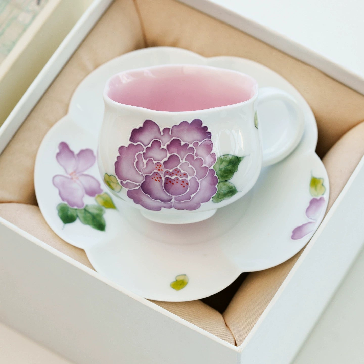 Fine china teacup featuring hand-painted peony petals