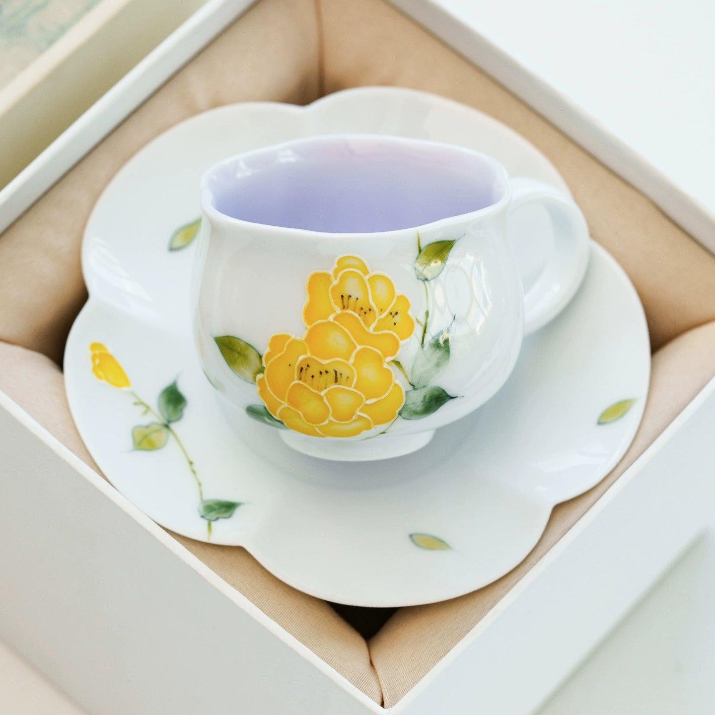 Fine china teacup featuring hand-painted yellow blossoms