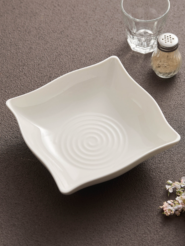 Fine dining presentation on white ceramic dish