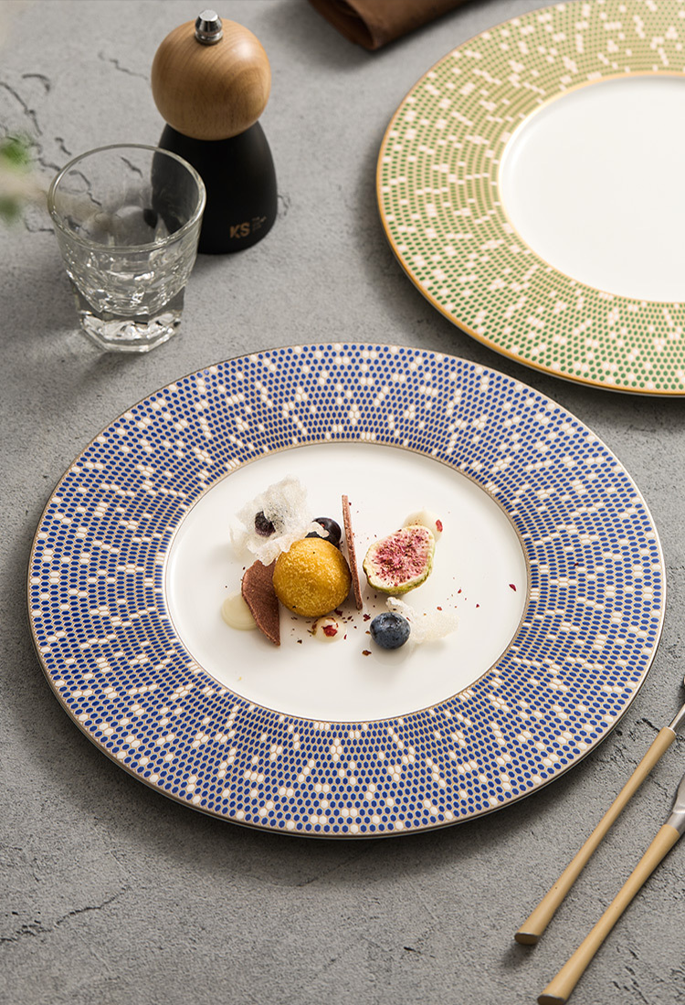 Fine dining table setting with high-contrast blue and white mosaic tableware.