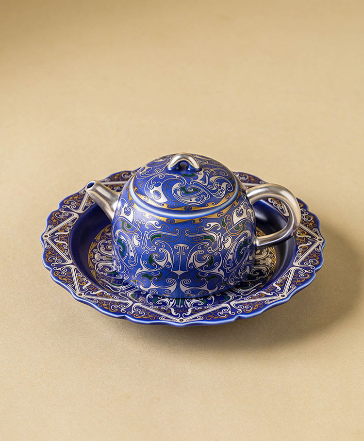 Fine porcelain teapot with delicate silver filigree engravings
