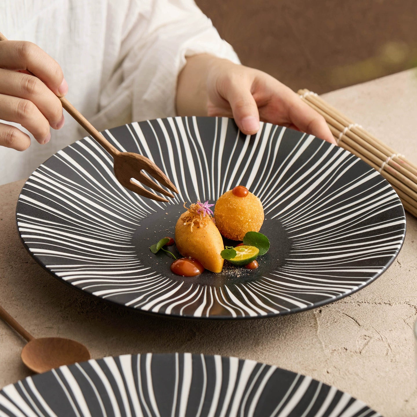 Food styling on black burst-pattern ceramic plate

