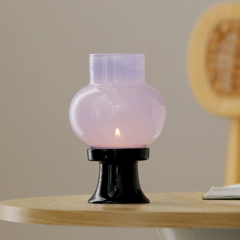GOSEUNG glass aroma candle lamp with warm candlelight glow on wooden table.