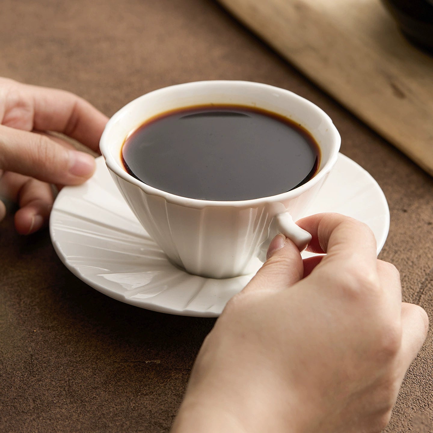GOSEUNG origami porcelain cup with folded geometric design.