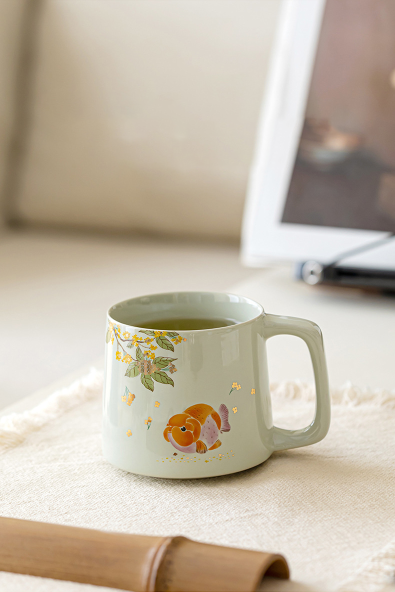 Gentle celadon mug with hand-painted fish and flowers