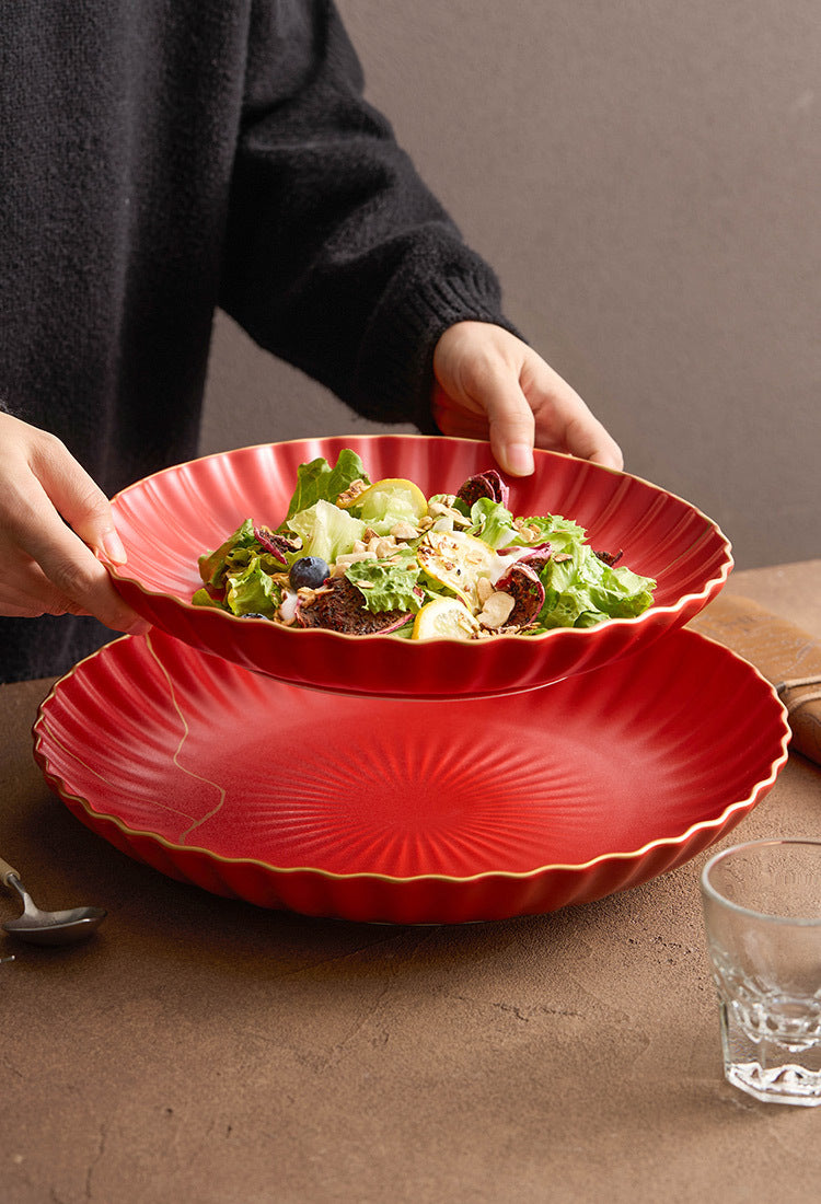 Golden-detailed red ceramic bowl for elegant tableware