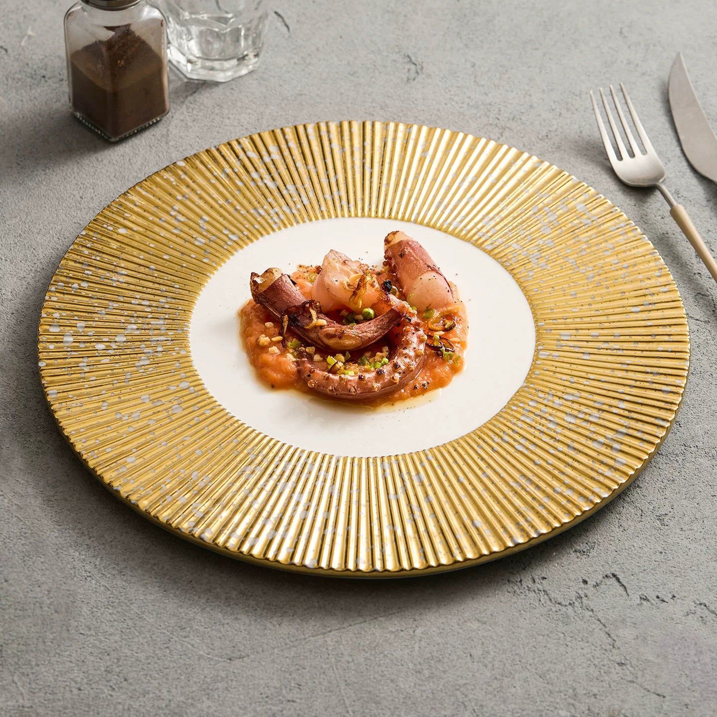 Golden radial gear charger plate with 12-inch diameter for luxury table settings.