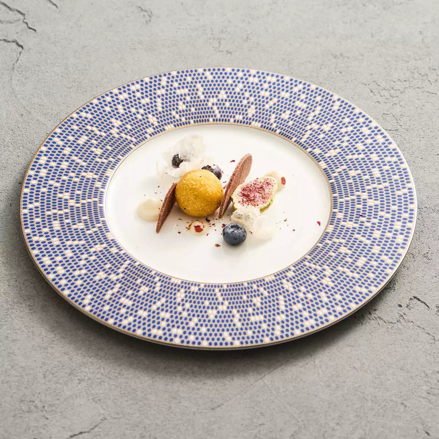 Gourmet dessert plating featuring figs and blueberries on a Platinum Blue mosaic dish.
