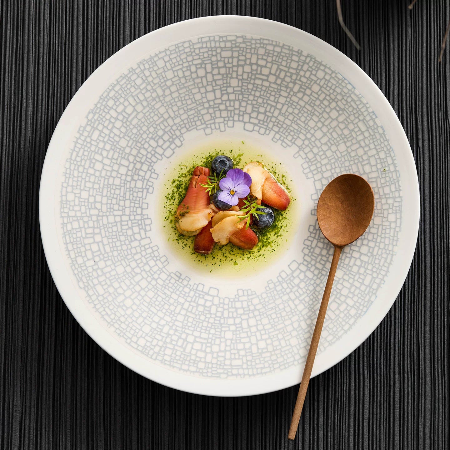 Gourmet seafood plating on a GOSEUNG mosaic-patterned shallow soup dish.