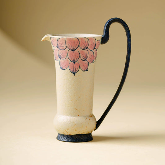 Hand-painted floral ceramic pitcher with curved handle